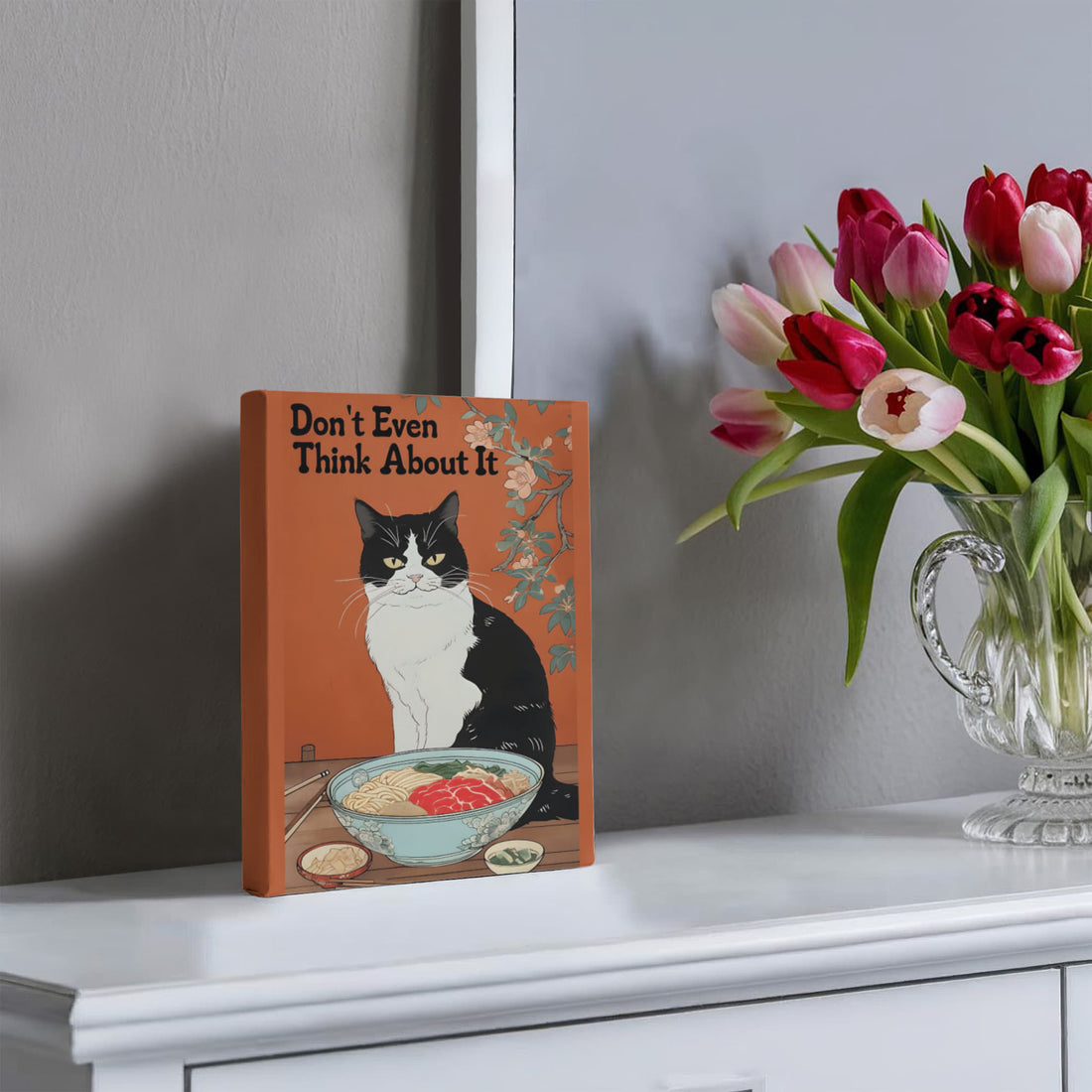“Don't Even Think About It,” this canvas brings humor and personality no-nonsense tuxedo cat guarding its ramen bowl.