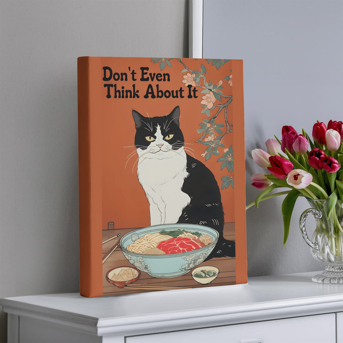“Don't Even Think About It,” this canvas brings humor and personality no-nonsense tuxedo cat guarding its ramen bowl.